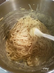 Stirring the egg and cheese into hot pasta. © cmurraycook.com