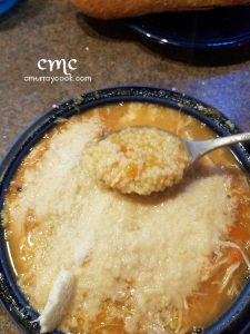 A finished bowl of my grandmother's chicken soup, covered in grated cheese. © cmurraycook.com