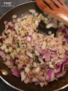 onions and garlic sauteeing in a frying pan. © cmurraycook.com
